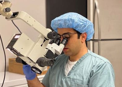 Man Looking into Medical Equipment